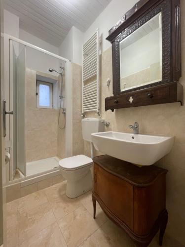 a bathroom with a sink and a toilet and a shower at Ninfea Como Lake - La casa del viandante in Bellano