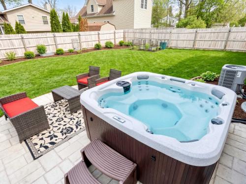 a jacuzzi tub in a backyard with a yard at Spacious Northfield 4BR Escape near Cuyahoga Valley in Northfield
