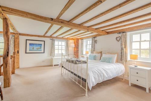 a bedroom with a bed and two windows at 6 Bed in Hadlow Down oc-g36329 in Hadlow Down
