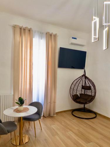a living room with a table and chairs and a window at Onny's Palace in Bari