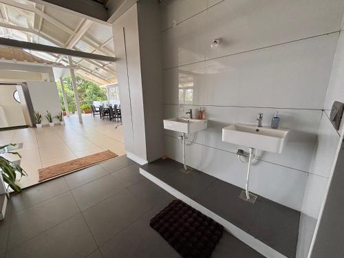 a bathroom with two sinks on the wall at Nirvana Yogashala Retreat in Mysore