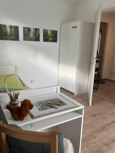 a table with a teddy bear sitting on top of it at Gemütlicher Bungalow bei Aalen,Abtsgmünd in Abtsgmünd
