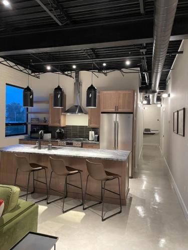 a kitchen with a large kitchen island with bar stools at Classic Pied a Terre in Benton Harbor