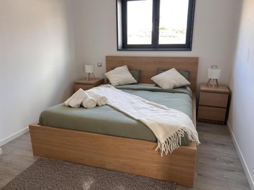 a bedroom with a large wooden bed with two night stands at Bio Home La Asomada in Tías