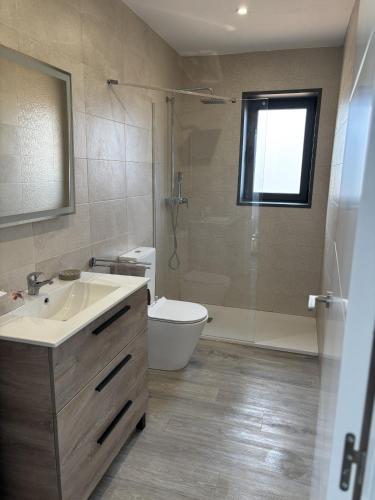 a bathroom with a sink and a toilet and a shower at Bio Home La Asomada in Tías