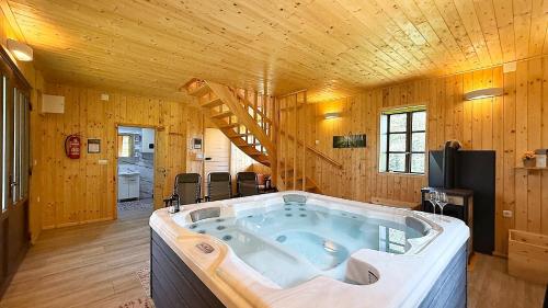 a large bath tub in a room with wooden walls at House Toni by Villas Guide in Brod Moravice
