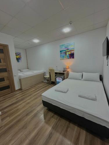 a bedroom with a bed and a desk in it at Hotel BK in Kyiv