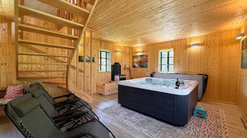 a bathroom with a large tub in a wooden cabin at House Toni by Villas Guide in Brod Moravice