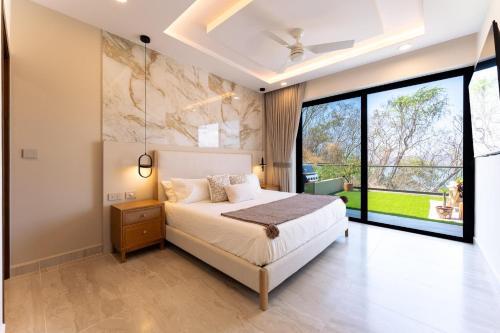 a bedroom with a bed and a large window at 3101 - Paradise Cove 1A Violin in Tangolunda