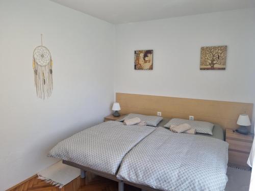 a bedroom with a bed and two pictures on the wall at Apartment Drejca in Kobarid