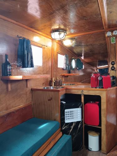 a kitchen in an rv with a sink and a table at The Boat in Ovar