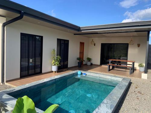 a swimming pool in the backyard of a house at Villa Shambala Arenal Volcano View Private Pool 6 Guests in Tanque
