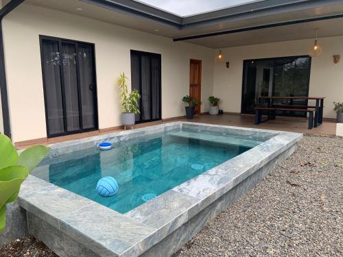 a swimming pool in the backyard of a house at Villa Shambala Arenal Volcano View Private Pool 6 Guests in Tanque