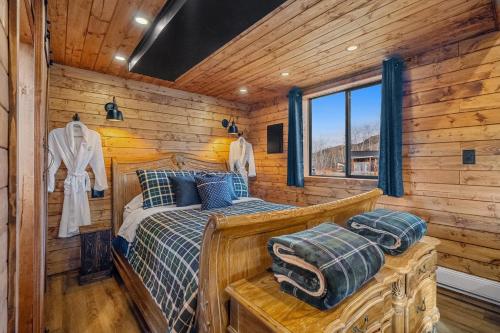 a bedroom with a bed in a log cabin at River Retreat Kananaskis in Turner Valley