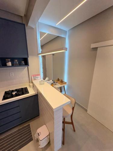 a kitchen with a counter and a stove top oven at Modern apartment, with excellent location in Macapá