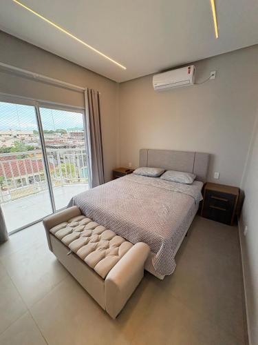 a bedroom with a bed and a large window at Modern apartment, with excellent location in Macapá