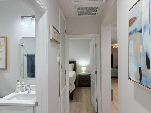 a bathroom with a sink and a room with a bed at Chic 3BR, 2BA -Brand New! in Englewood