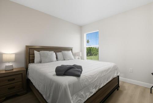 a white bedroom with a large bed and a window at Chic 3BR, 2BA -Brand New! in Englewood