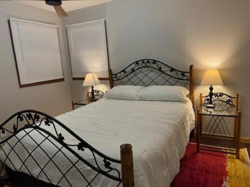 a bedroom with a large bed and two lamps at Sunnyside Rental-Entire vacation home 3 Bedroom 2 Bathrooms 1 Kitchen in McHenry
