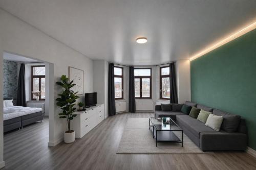 a living room with a couch and a table at MIILOX Apartments Chemnitz Hainstrasse in Chemnitz