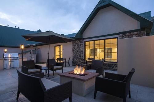 a patio with a fire pit and tables and chairs at Residence Inn by Marriott Durango Downtown in Durango