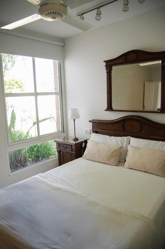 a bedroom with a large bed and a large window at AMADO-Un sueño in Junín