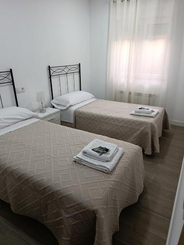 a room with two beds with towels on top of them at La ERA in Aldeadávila de la Ribera