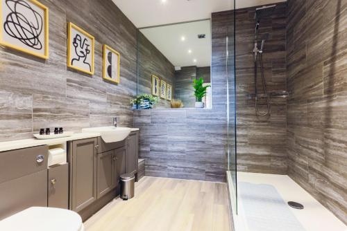 a bathroom with a shower and a sink at Luxury 1BR Seafront Apartment in Cardiff