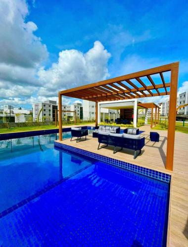 a swimming pool with a pavilion next to a swimming pool at Conforto103 in Caruaru