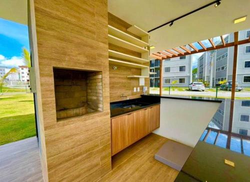 a kitchen with a counter and a large window at Conforto103 in Caruaru
