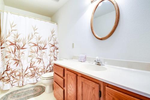 a bathroom with a sink and a toilet and a mirror at Wren Ridge in Pagosa Springs
