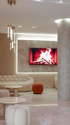 a living room with a fire in the fireplace at Hotel Donia Sfax in Sfax