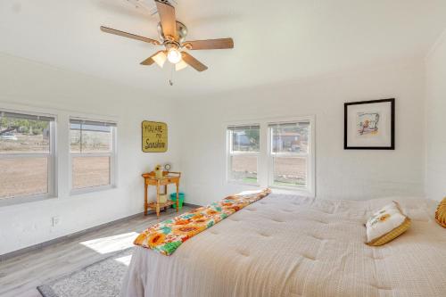 a bedroom with a bed and a ceiling fan at Route 66 Roadtripper Retreat w/ Private Backyard in Kingman