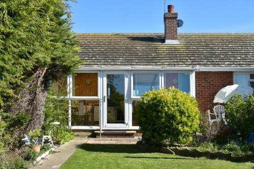 a house with a conservatory with a front door at Amazing Beachside 2BD Family Home with Garden in Cliftonville