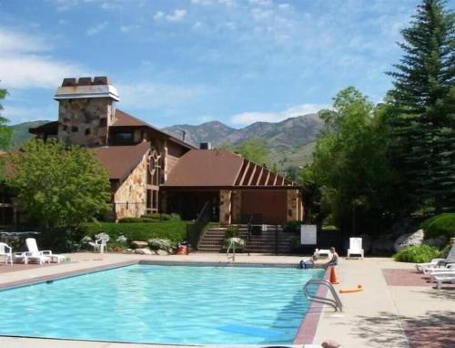 a house with a swimming pool in front of a building at Luxuriously Contemporary Condo WL1401 Powder Mtn in Eden