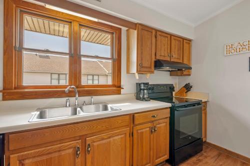a kitchen with a sink and a stove and a window at Ocean Views From Every Room in Kitty Hawk