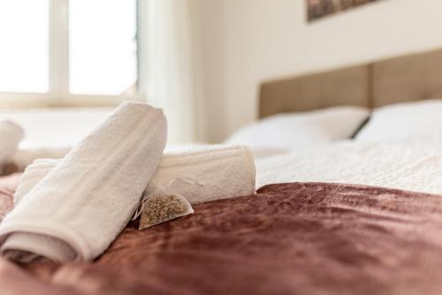 a rolled up towel on top of a bed at Laguna Apartments in Pag