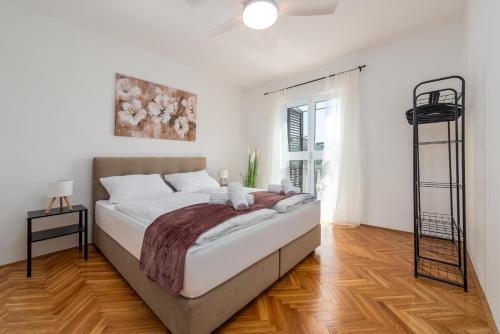 a bedroom with a large bed in a room at Laguna Apartments in Pag