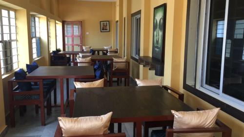 Vajrabodhi Guest House في بود جايا: صف من الطاولات والكراسي في المطعم