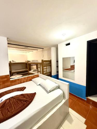 a bedroom with a large white bed in a room at Hotel Sol y Luna 1 in Medellín