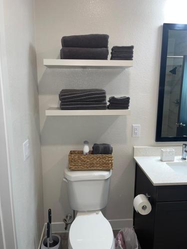 a bathroom with a white toilet and a sink at Arthouse in Houston