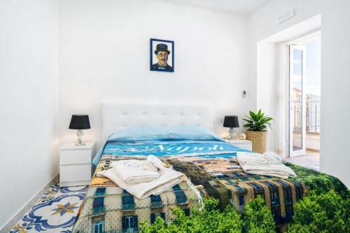 a white bedroom with a bed with a blanket at Fantasy House Suites in Forio d'Ischia