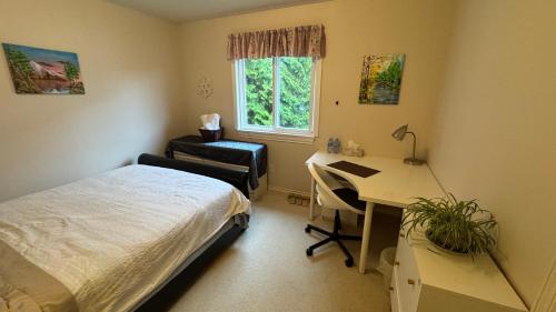a bedroom with a bed and a desk and a deskablish at Warm house3 in Coquitlam
