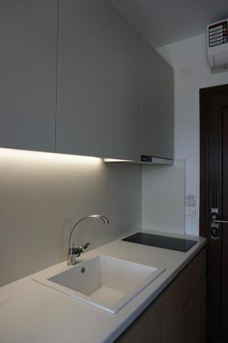 a white kitchen with a sink and a counter at Aria Vista Chalkidiki in Agios Nikolaos