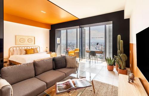 a living room with a couch and a bed at Casa Magenta by Kukun in Mexico City