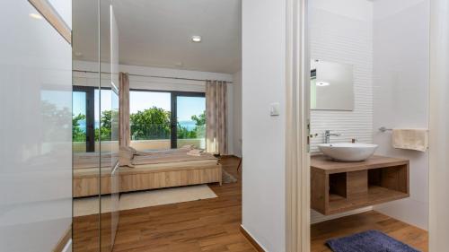 a bathroom with a sink and a bath tub at Villa Angello in Matulji