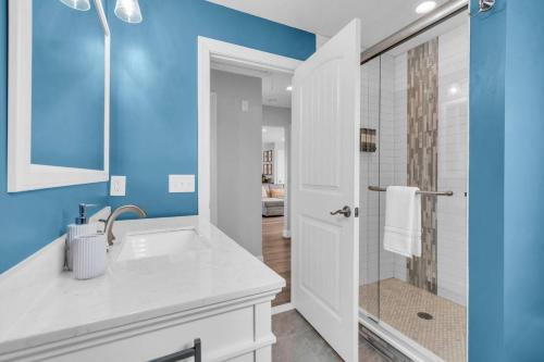 a bathroom with a white sink and a shower at Prof Cleaned | Fast WiFi | BBQ | Linen & Towels in Seaside Heights