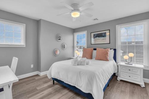 a bedroom with a bed and a desk and two windows at Prof Cleaned | Fast WiFi | BBQ | Linen & Towels in Seaside Heights