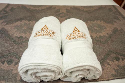a pair of white towels sitting on a table at Casa Antade Cusco in Cusco
