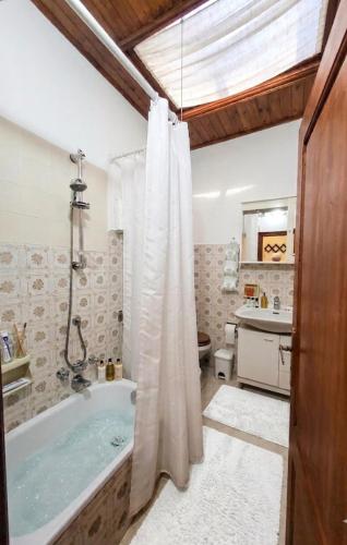 a bathroom with a tub and a sink at Borgo Maggiore in Radicofani